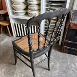 Napoleon III chair in black and gold wood with caning.