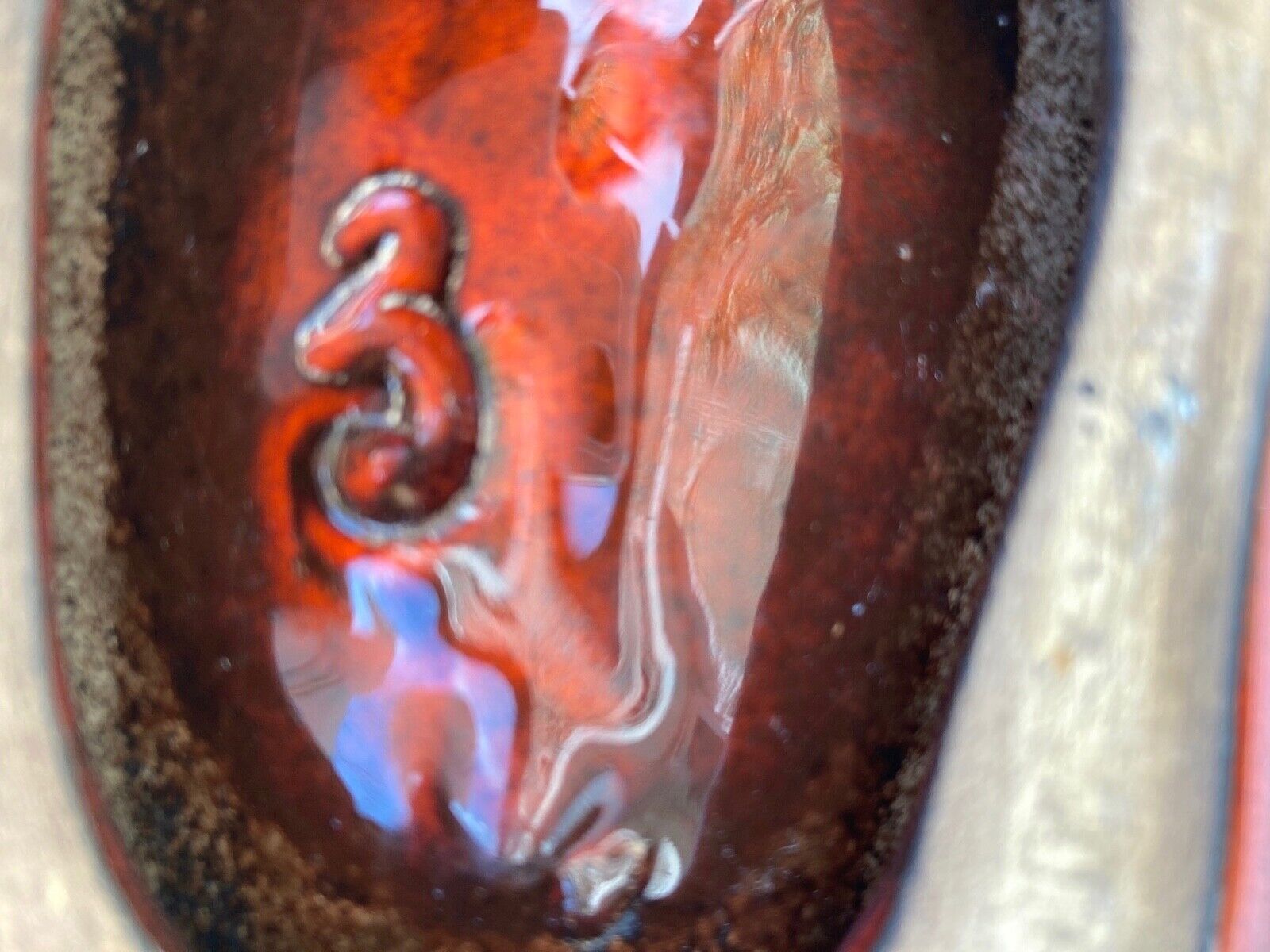 Enamelled ceramic flat monogram of Max Idlas on the back