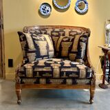 Armchair in a wooden confessional style with black and beige cotton.