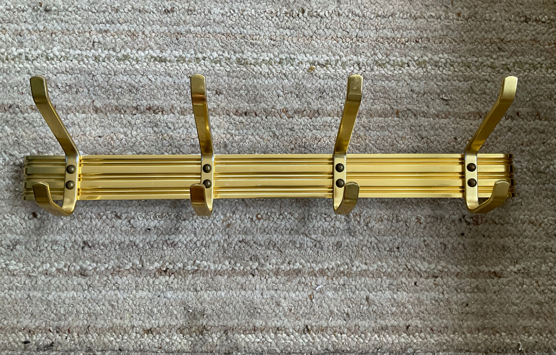Golden wall-mounted coat rack from the 70s.