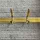 Golden wall-mounted coat rack from the 70s.