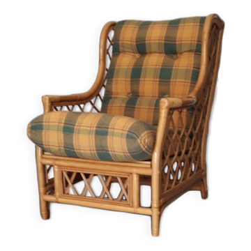 Vintage armchair in bamboo and rattan with a tartan pattern.