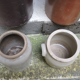 Collection of old sandstone pots with grease and mustard salting