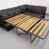 Vintage corner sofa composed of 3 modules in black leather with integrated bed.