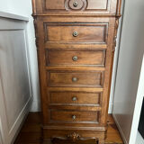 Solid wood storage furniture with a marble top.