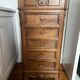 Solid wood storage furniture with a marble top.