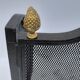 Wrought iron wire fenced fire with brass pine cone