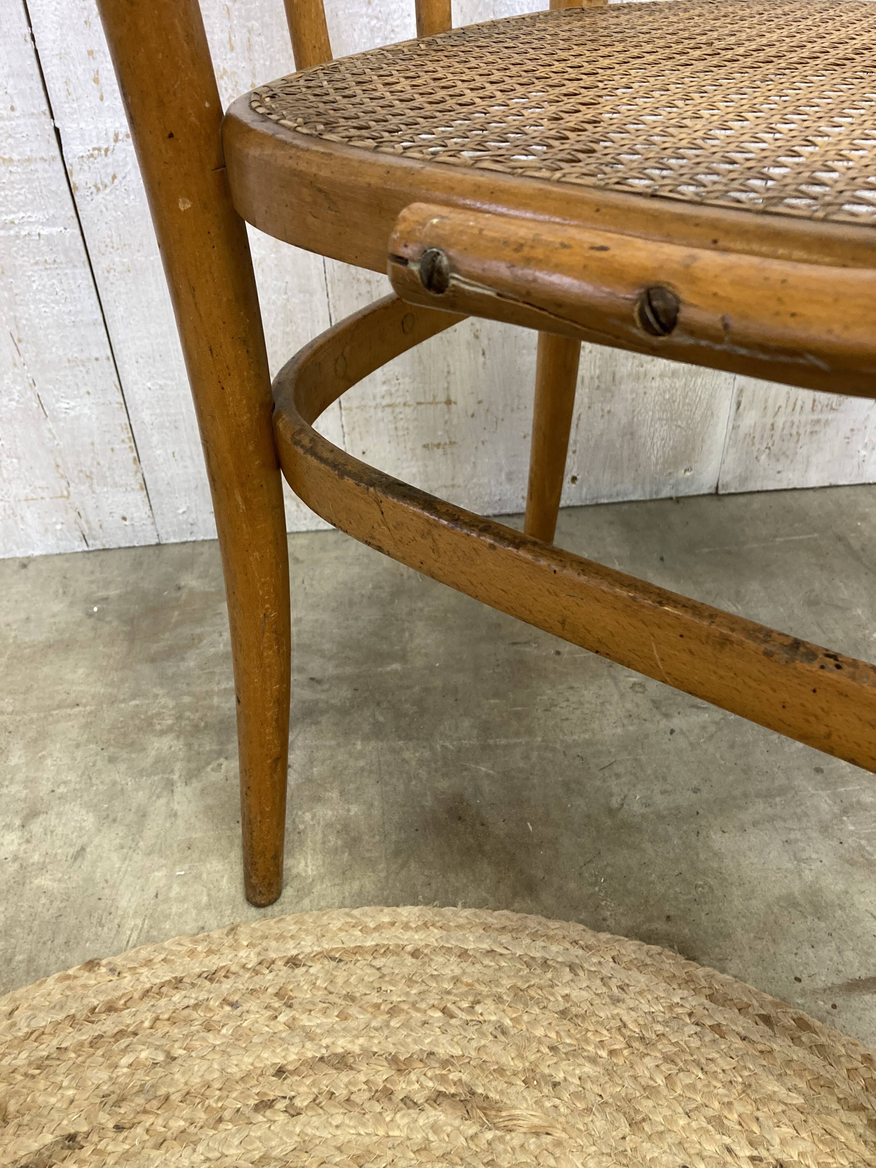 Curved wood and cane armchair