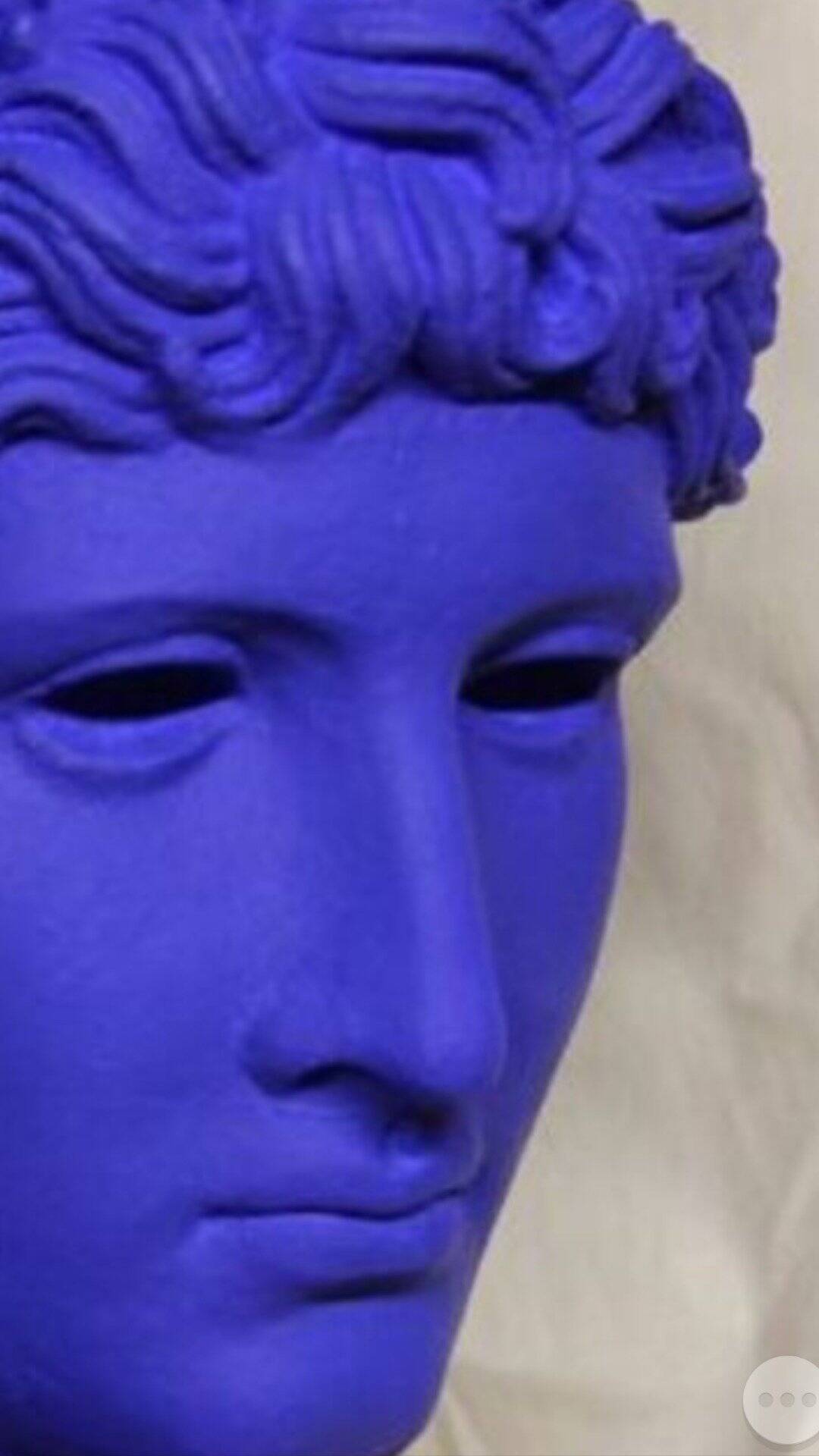 Large bust of a Greek Roman Apollo on a pedestal