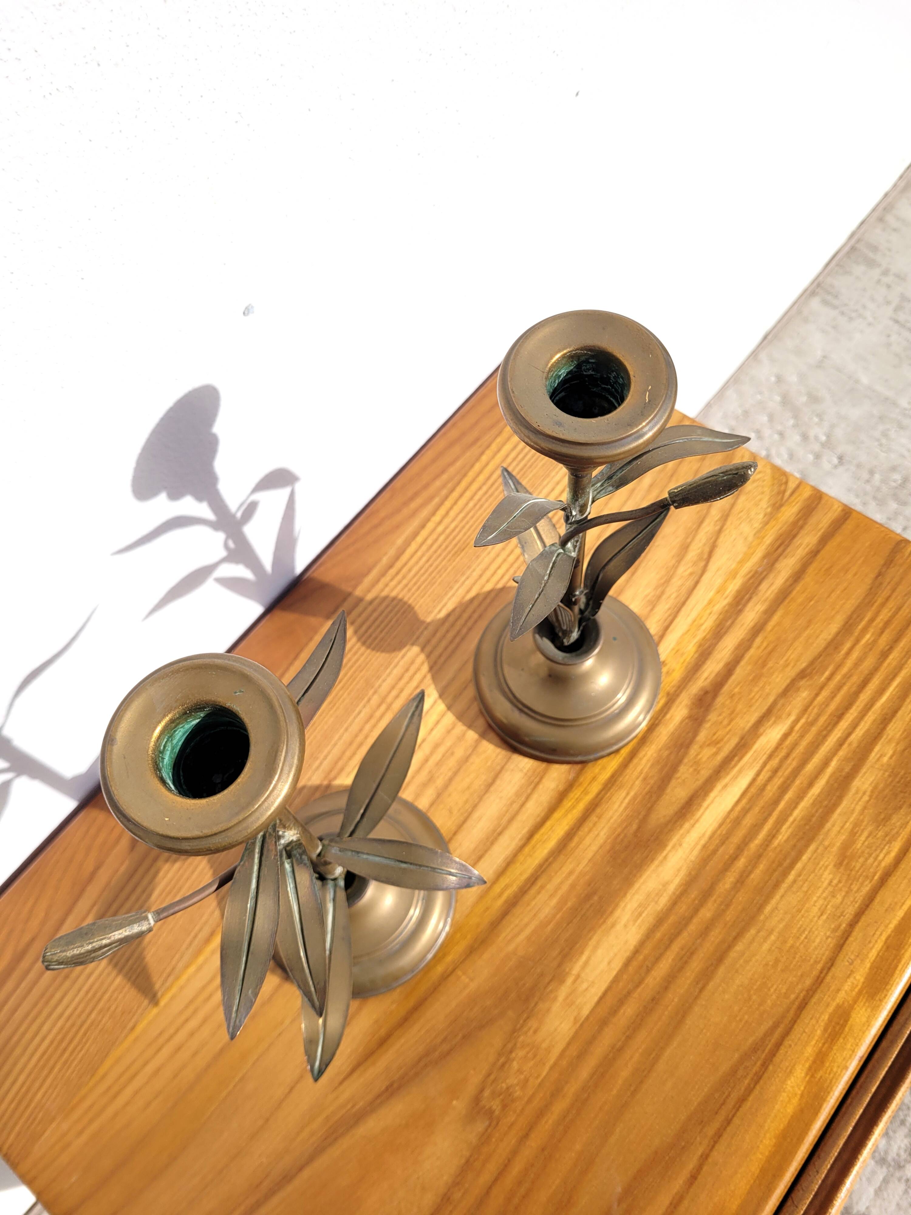 Pair of brass candlesticks with plant decoration
