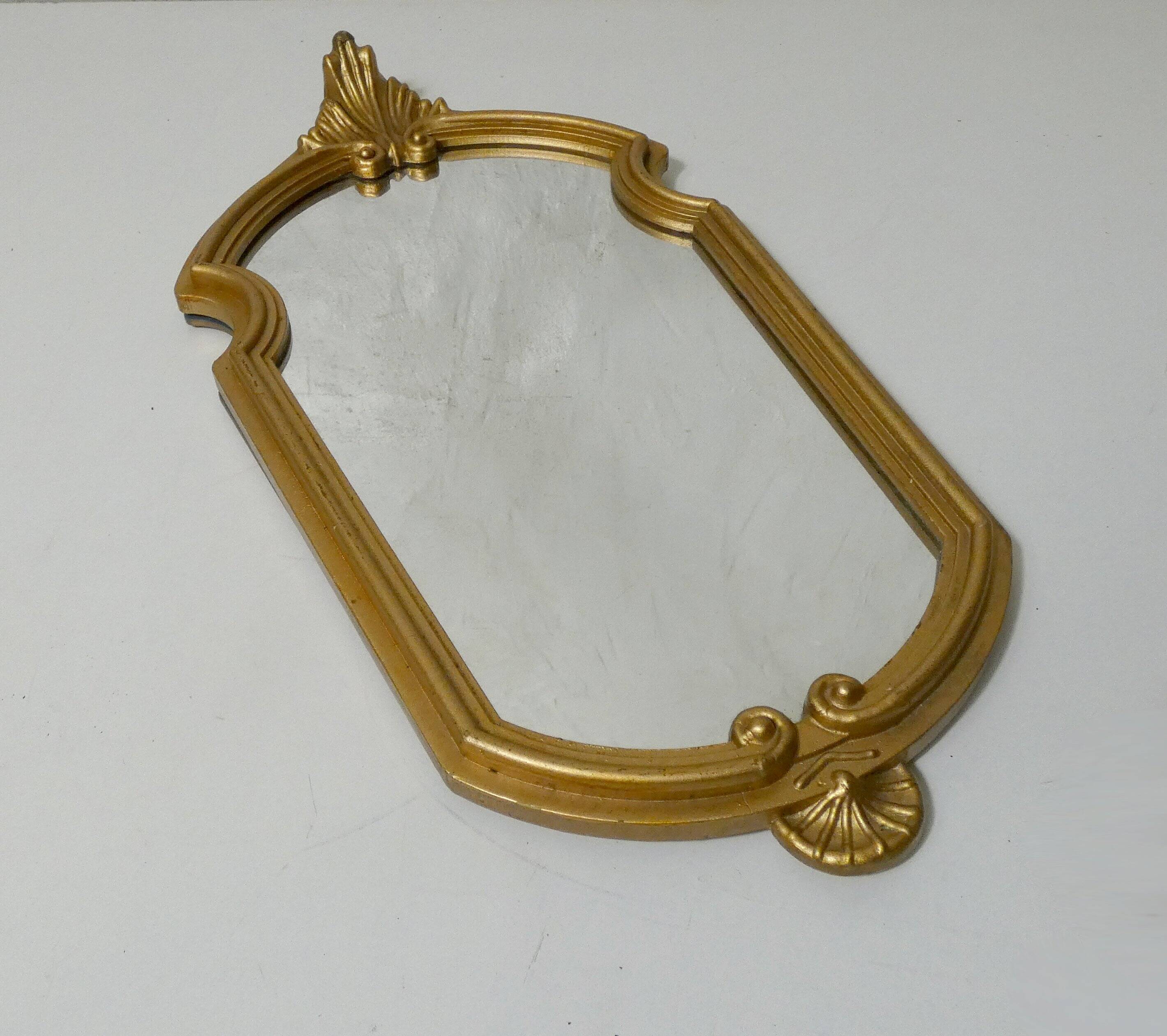 Antique Louis XV style mirror with a vintage carved gold frame.