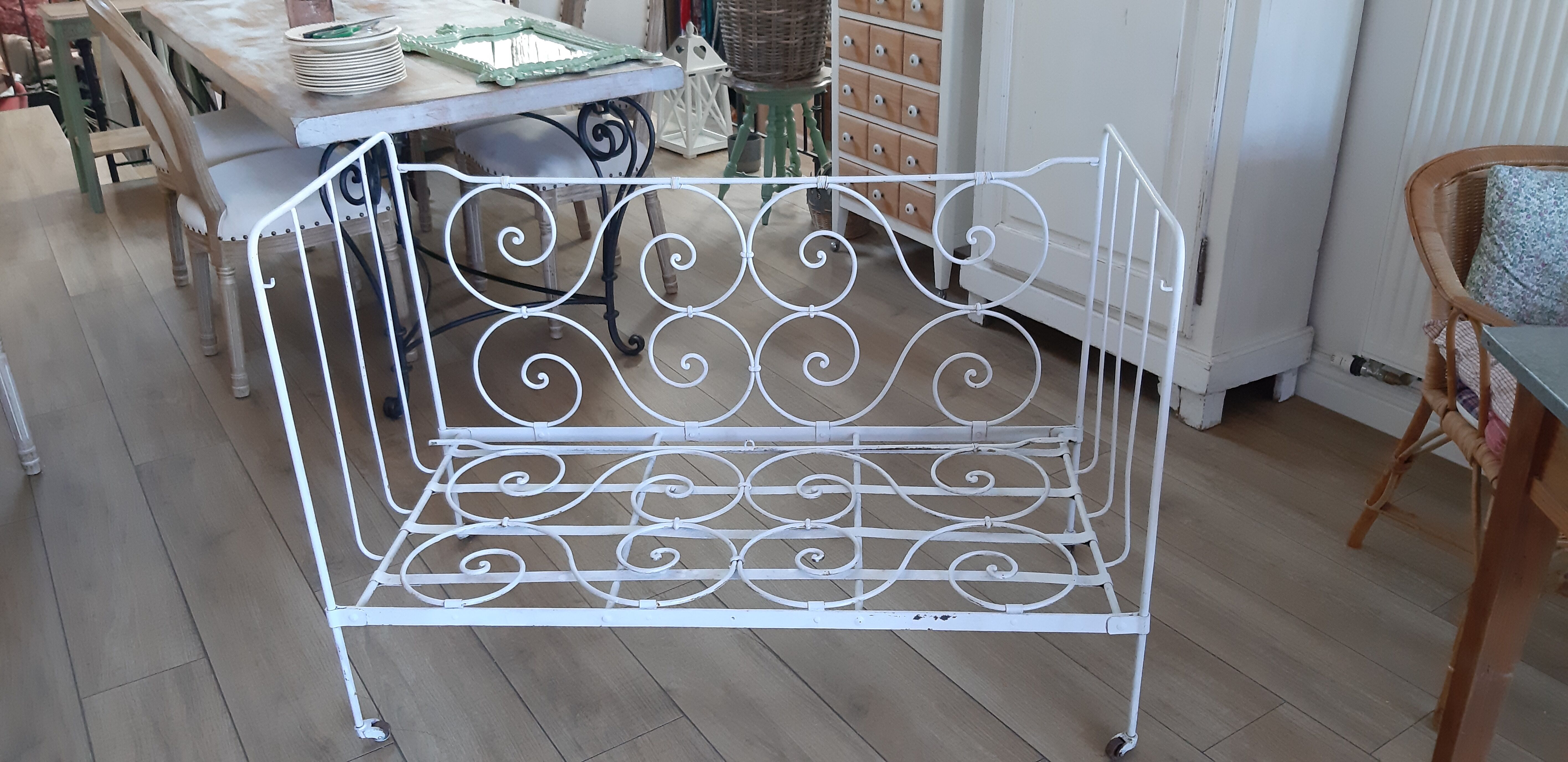 Wrought iron baby bed. Or bench seat of your choice