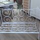 Wrought iron baby bed. Or bench seat of your choice