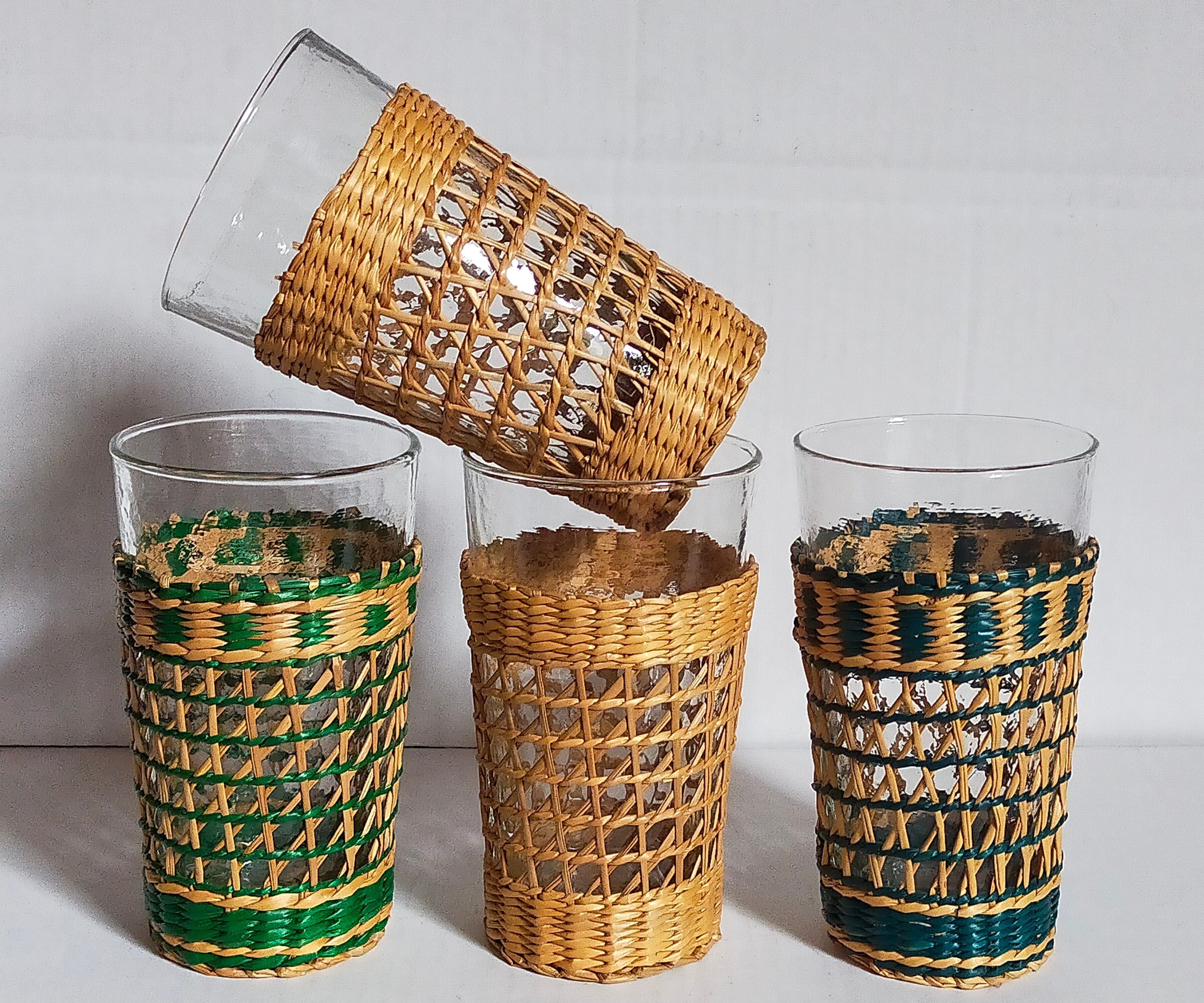Four long drink glasses in vintage woven rattan cases