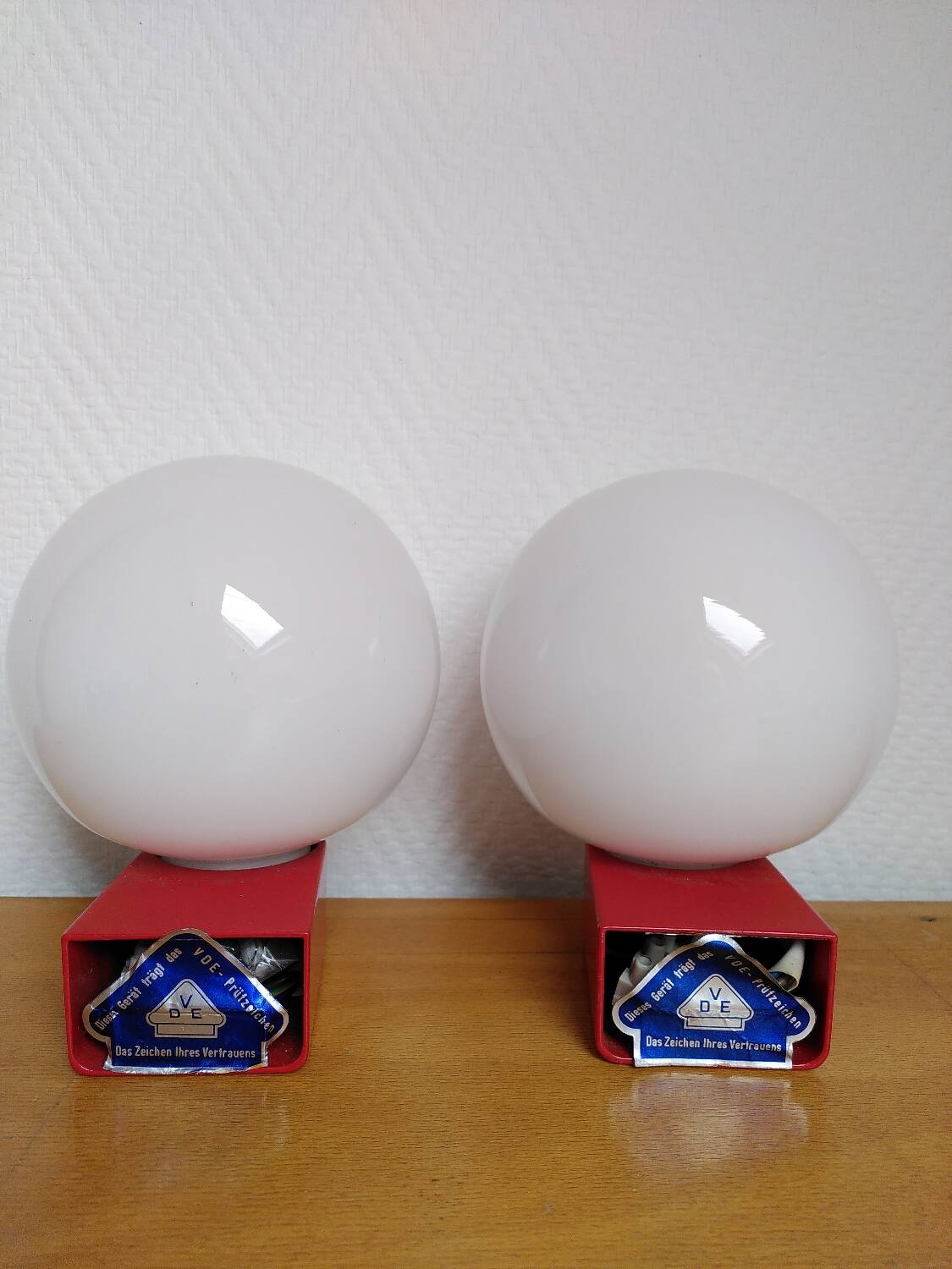 2 postmodern opaline and red metal wall lights, 1980