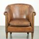 Vintage sheepskin club armchair finished with decorative nails