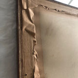 Old mirror with wooden frame and plaster moldings