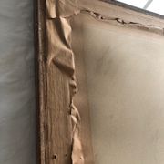 Old mirror with wooden frame and plaster moldings