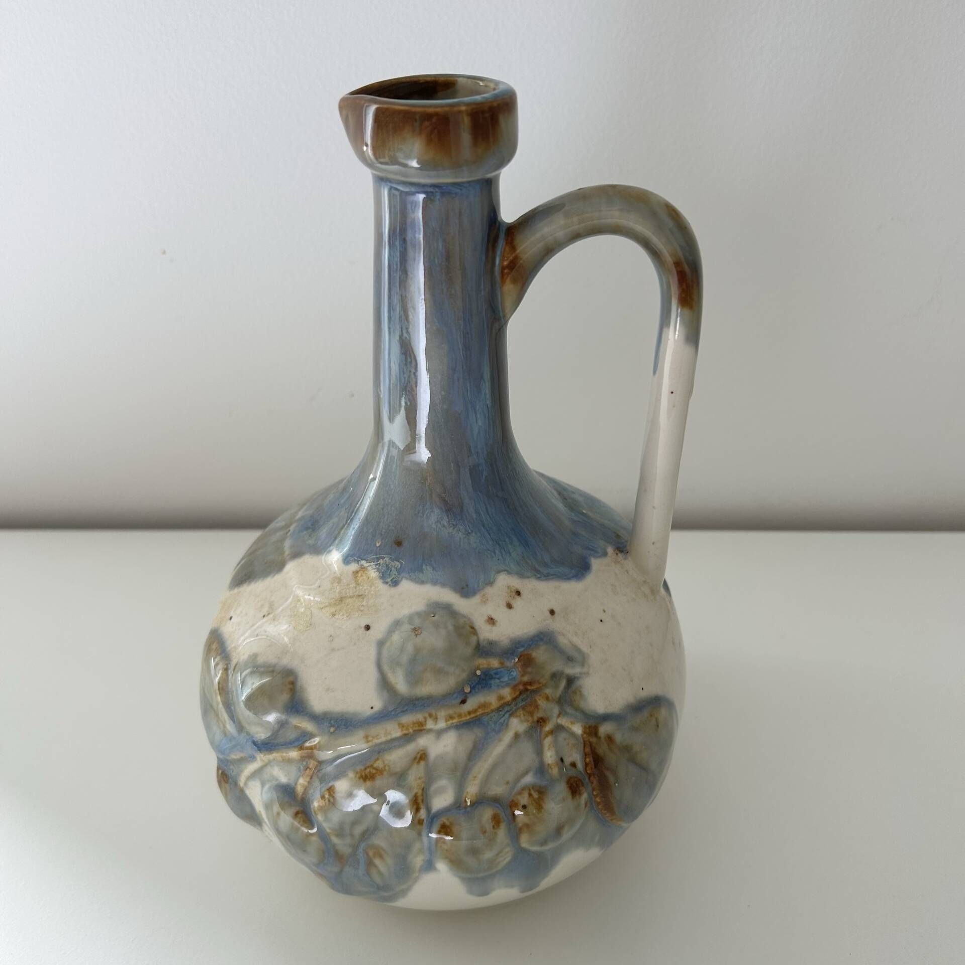 Cherry-decorated earthenware carafe