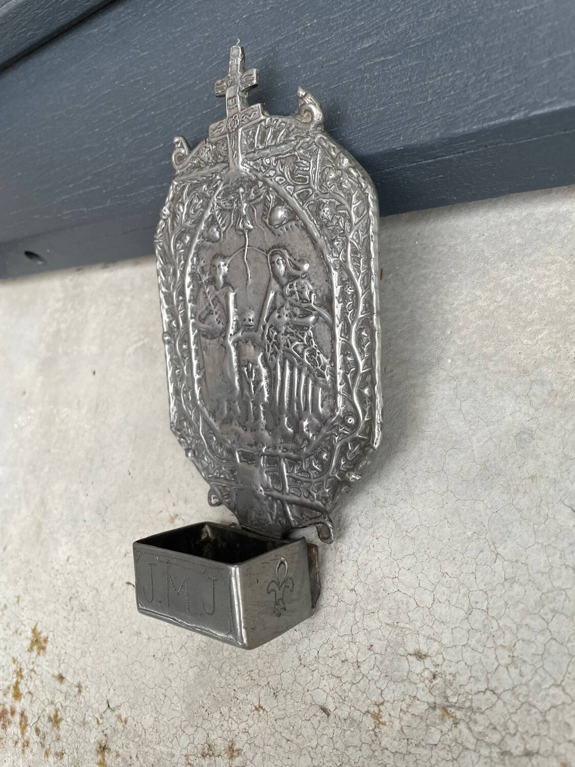 Small wall-mounted holy water font