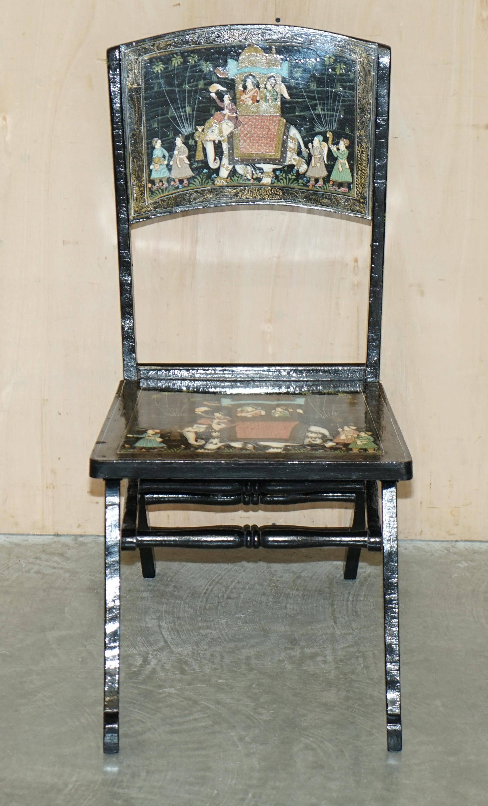 Pair of military folding chairs with Indian decoration.