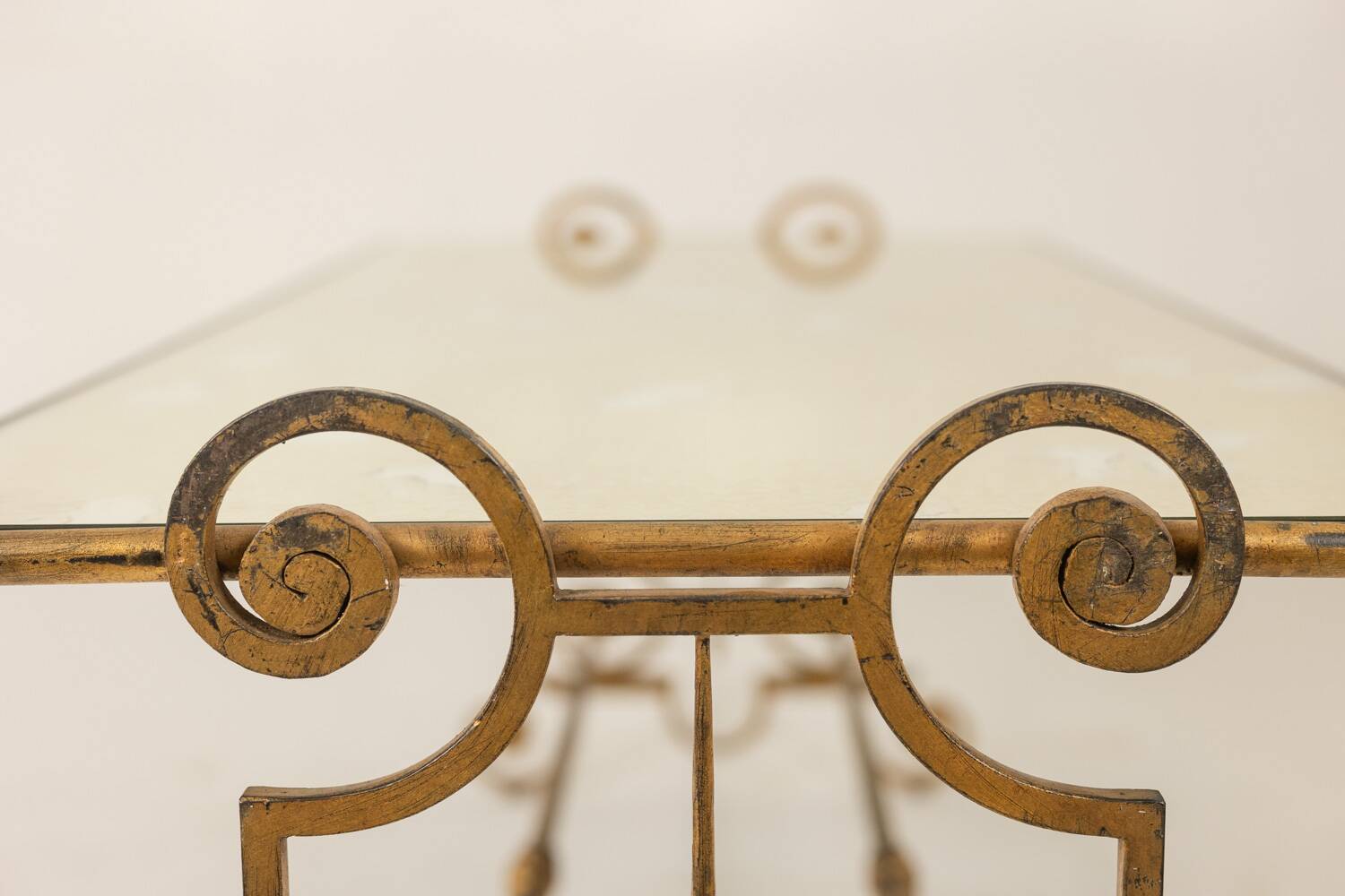 Gold wrought iron coffee table with a mirrored glass top. 1970s.