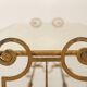 Gold wrought iron coffee table with a mirrored glass top. 1970s.