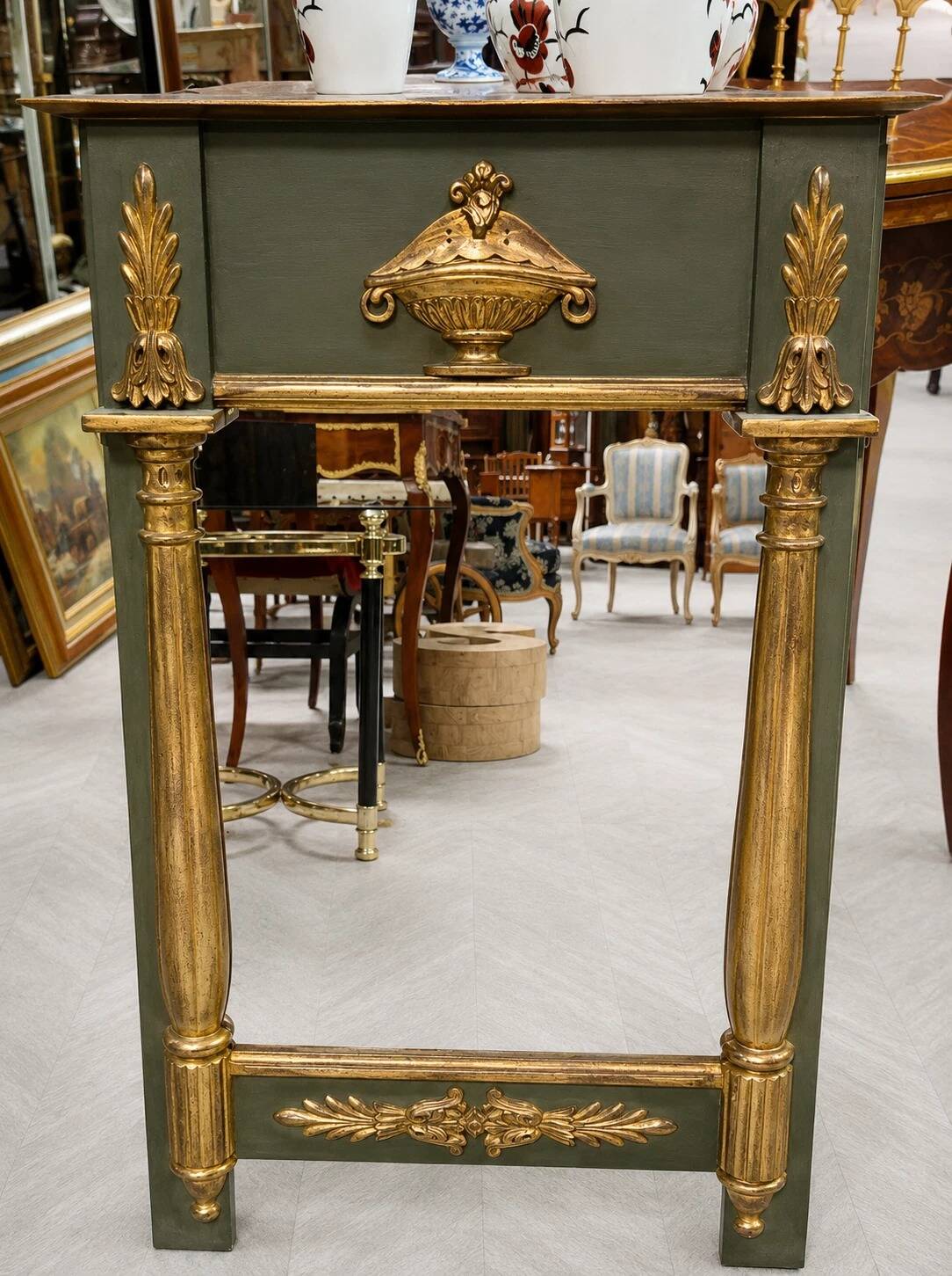 Empire-style mirror in deep green lacquered wood richly enhanced.