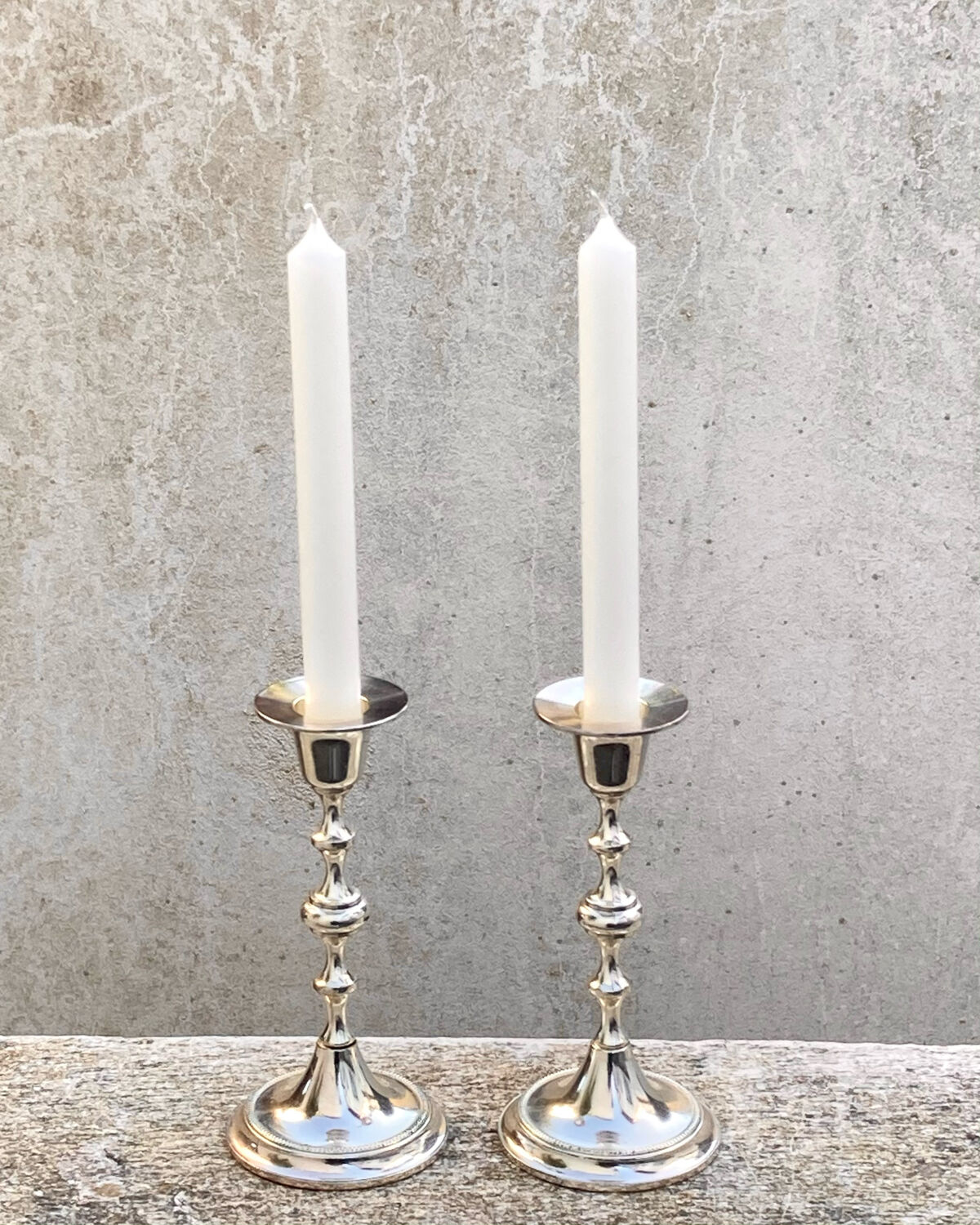 Two antique metal candle holders