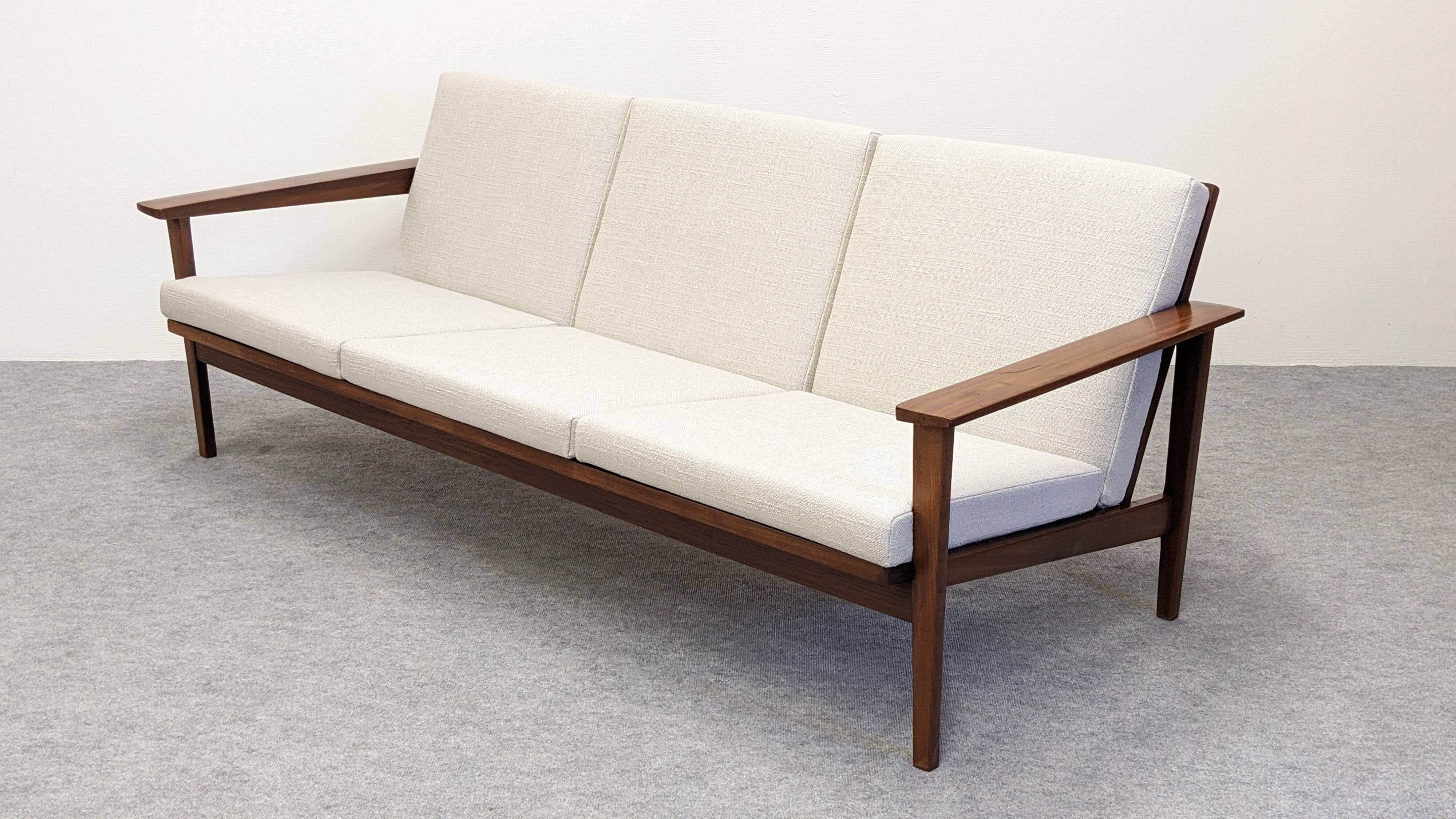 Three-seater modernist teak sofa, France circa 1950.