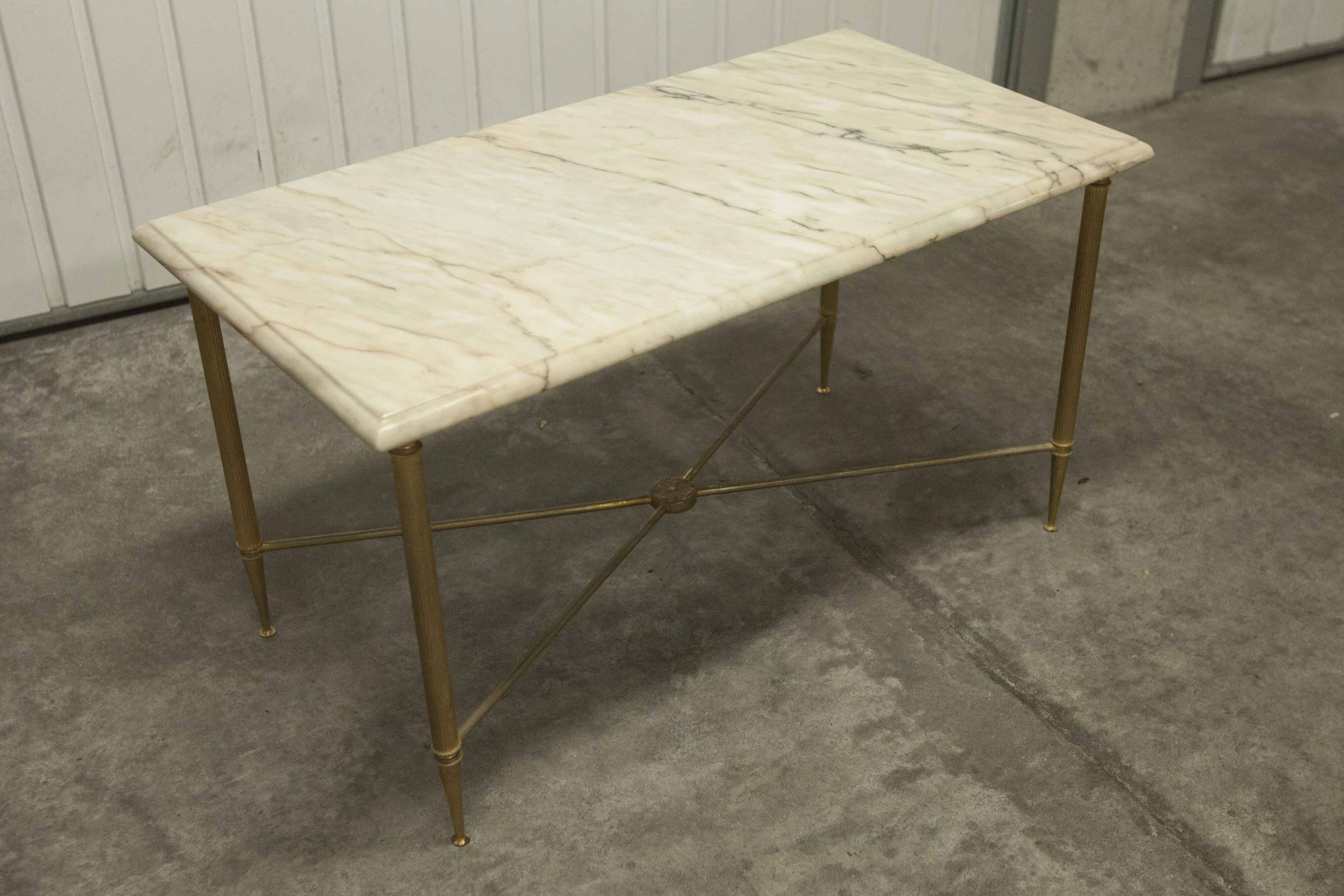 Marble coffee table with brass legs, height 46 cm.