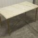Marble coffee table with brass legs, height 46 cm.