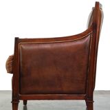 Comfortable Art Deco design armchair in cognac-colored sheepskin combined with wood