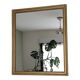Antique mirror with a gilded frame and beaded border.