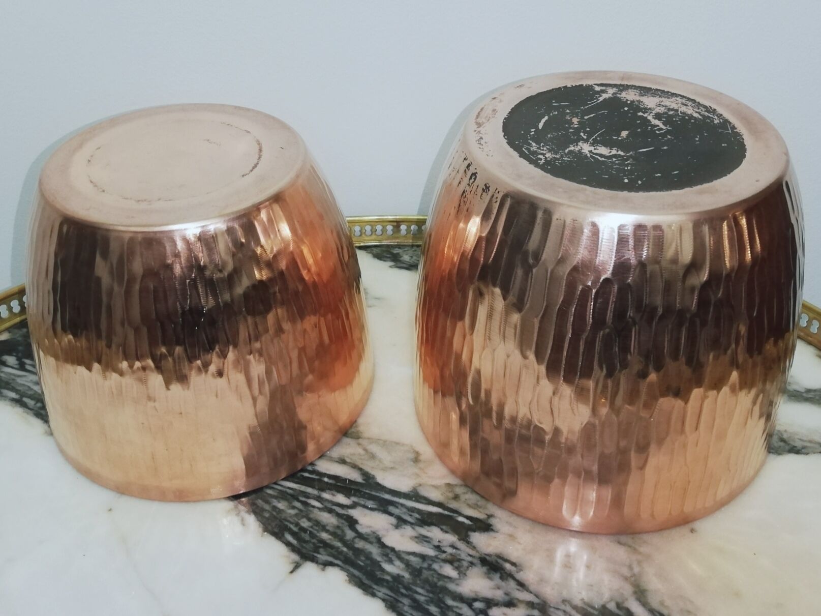 Duo of hammered copper pot covers
