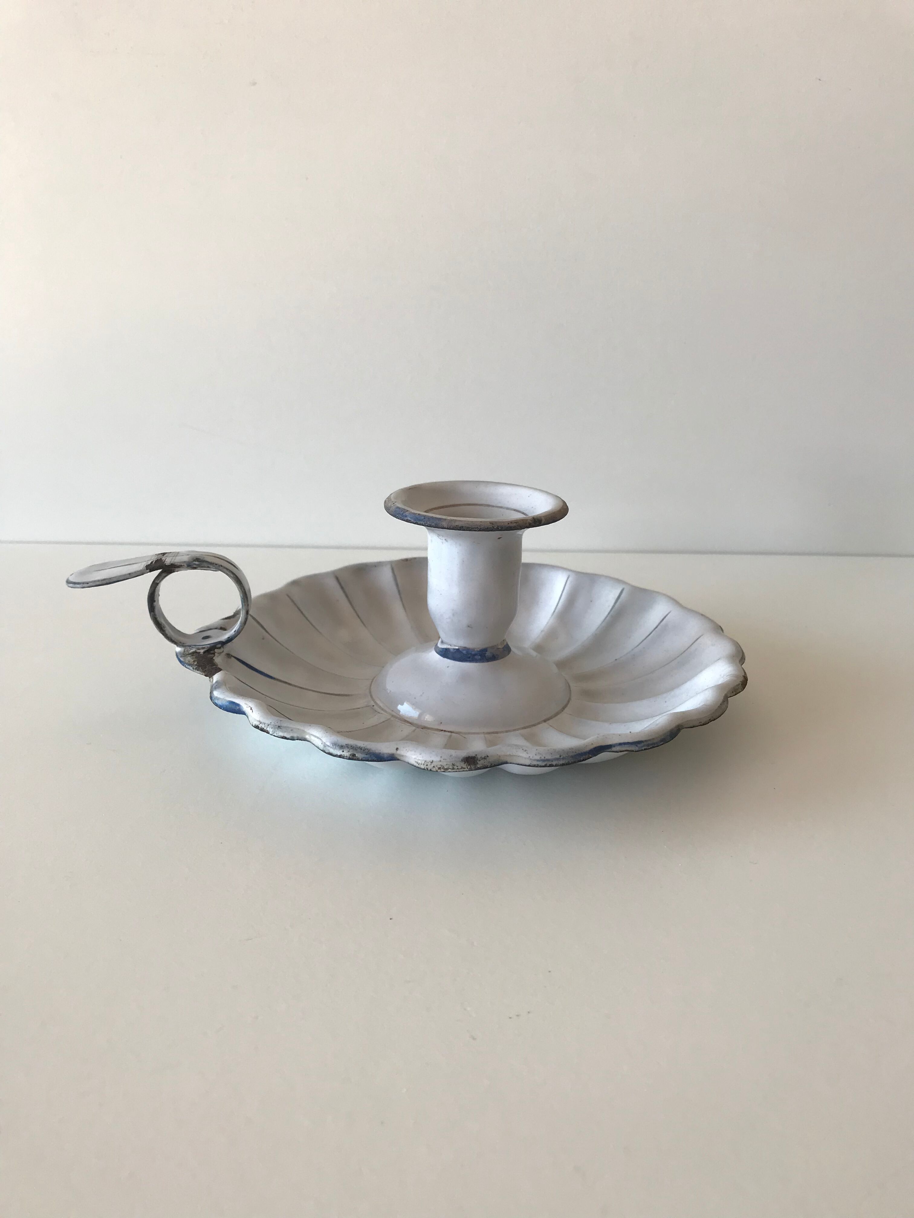 Candlestick in white enameled metal