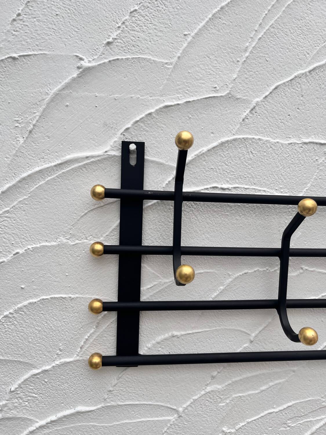 Iron and brass coat rack