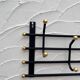 Iron and brass coat rack