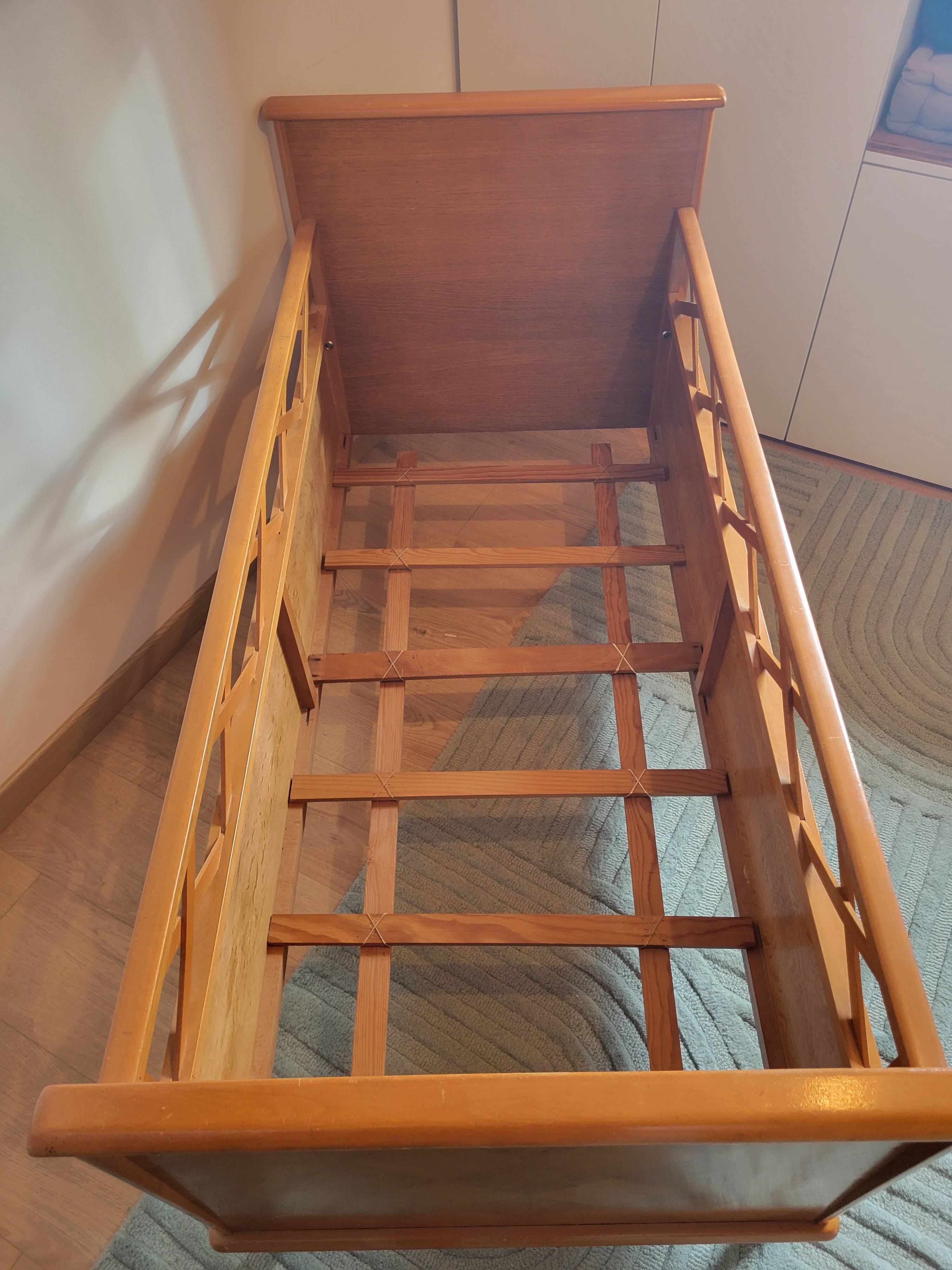 Vintage baby cot with splayed legs.