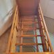 Vintage baby cot with splayed legs.