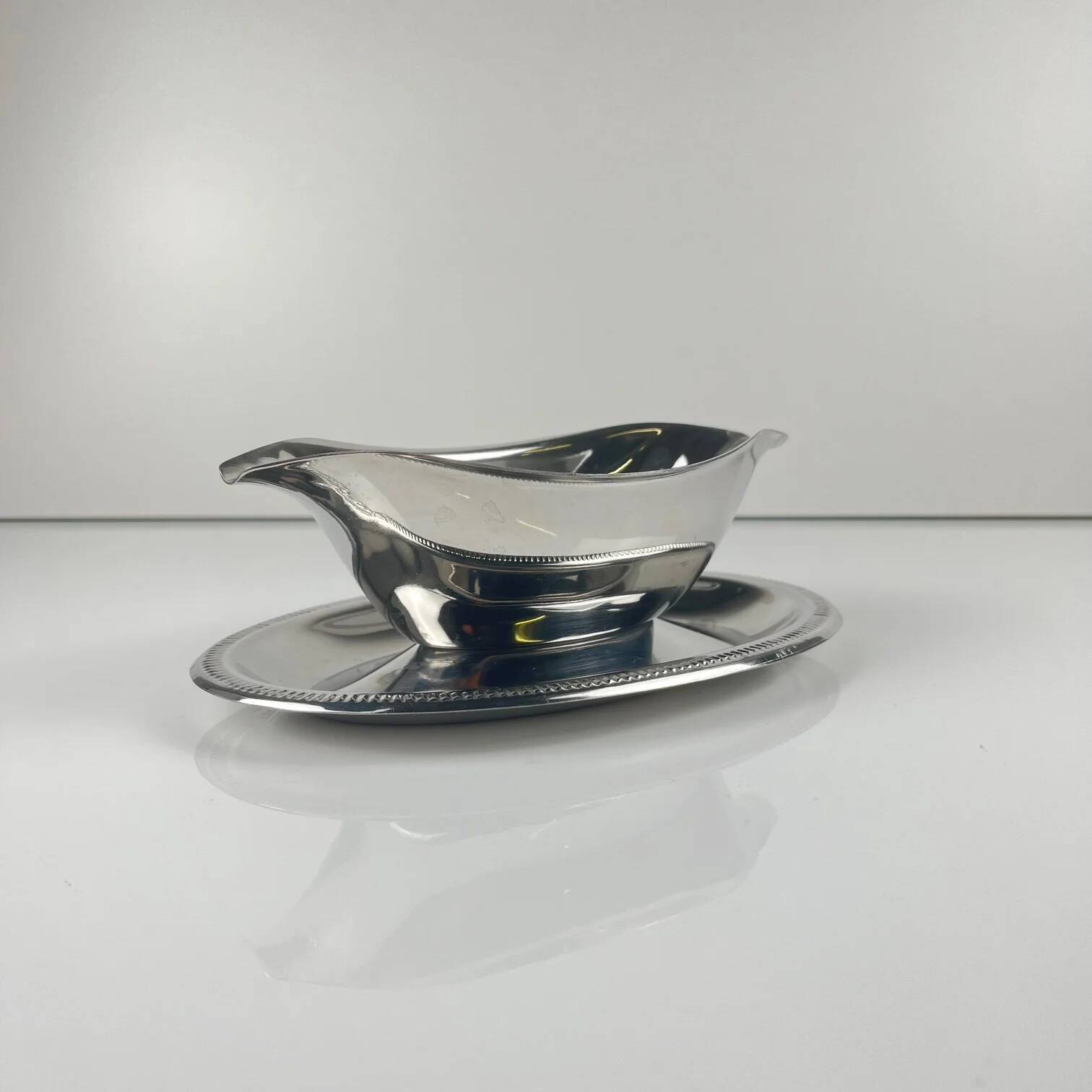 Metal sauceboat in Empire style, silver colour.