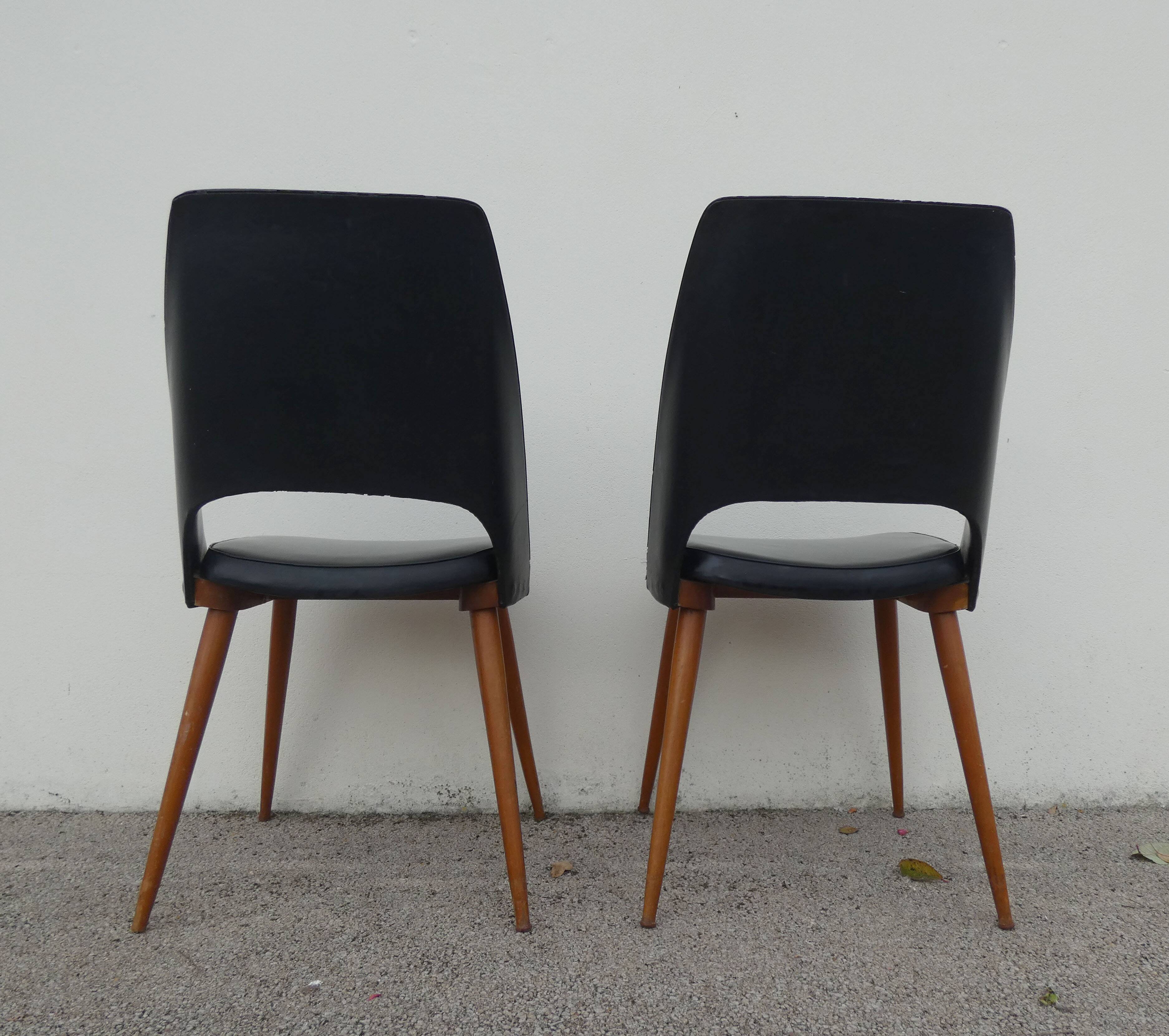2 chairs in black skai compass legs Louis Paolozzi