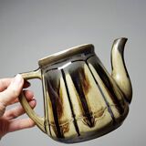 A pair of small vintage teapots in the Art Deco style reminiscent of Denbac.