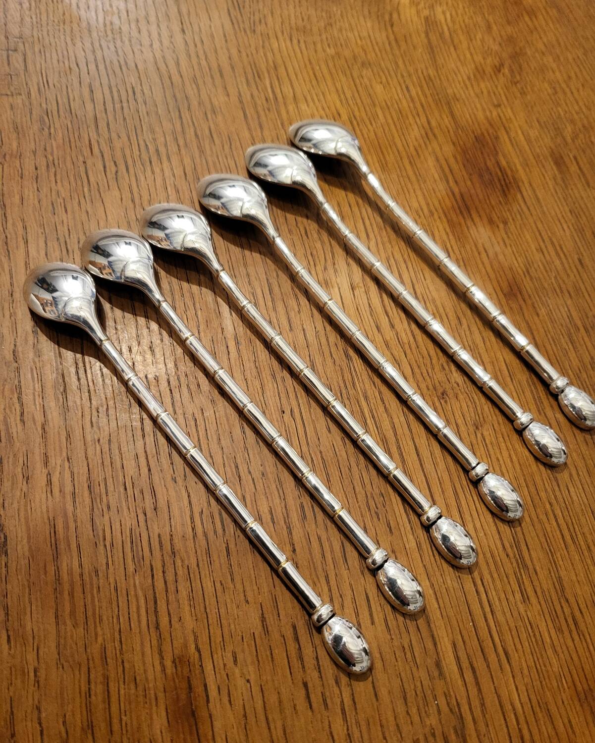 6 long silver-plated metal spoons