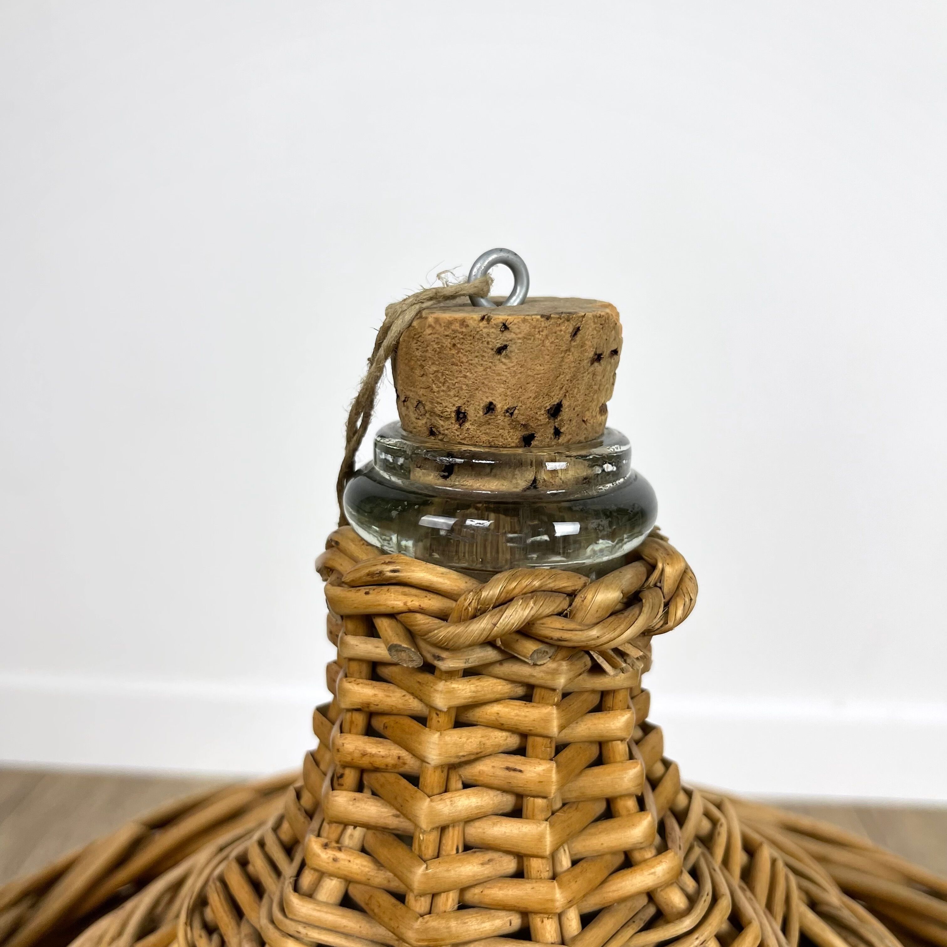 Old demijohn in her wicker basket