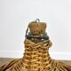 Old demijohn in her wicker basket