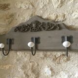 Wall-mounted wooden coat rack with 3 hooks.