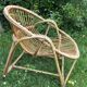 A pair of rattan armchairs