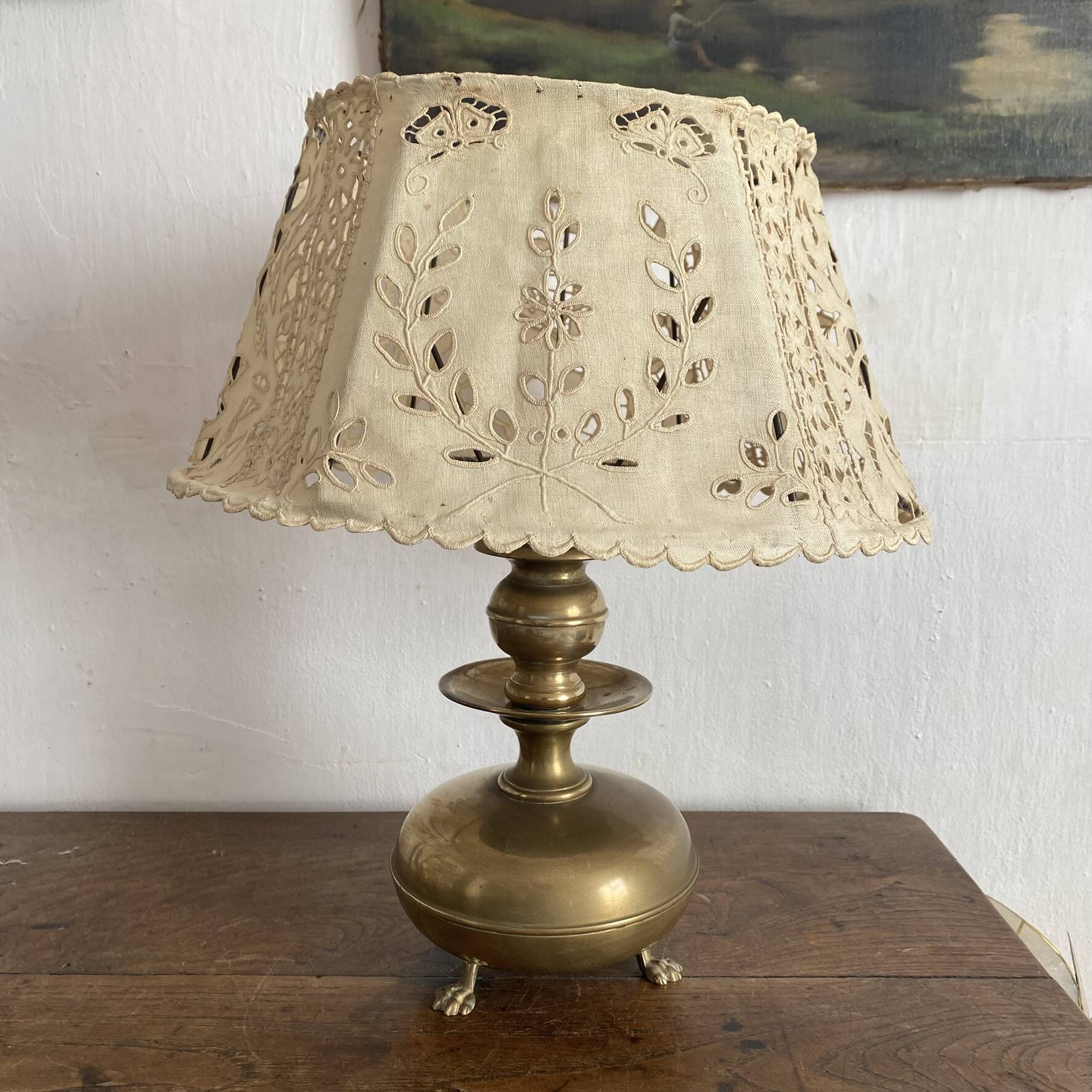 Antique brass lamp with embroidered openwork shade.