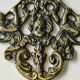 Decorative coat hook with cherubs/putti in aged brass.